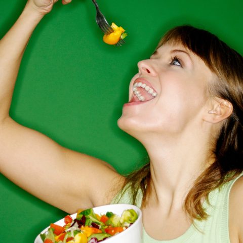 Woman enjoying a bowl of salad