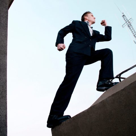 Businessman running up the stairs